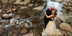 Bride and Groom by river in Yosemite