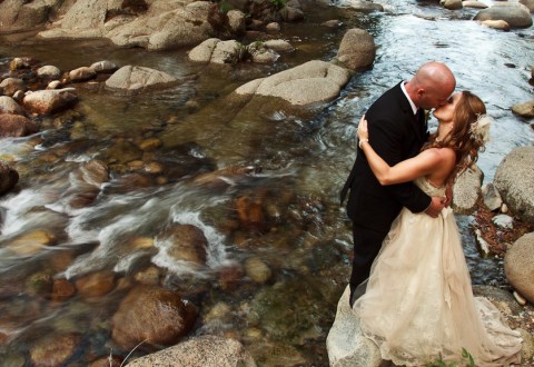 Bride and Groom by river in Yosemite